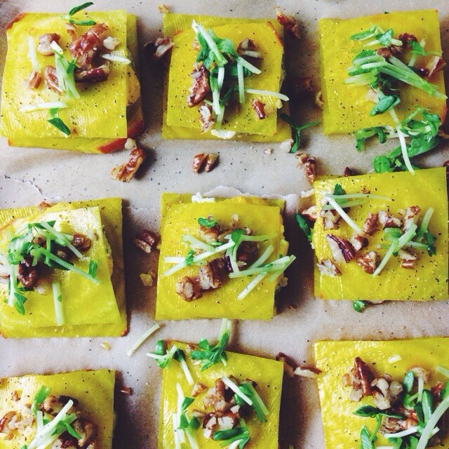 Golden Beet Ravioli with herbed cashew cheese filling, bell pepper sauce, tarragon & pecans