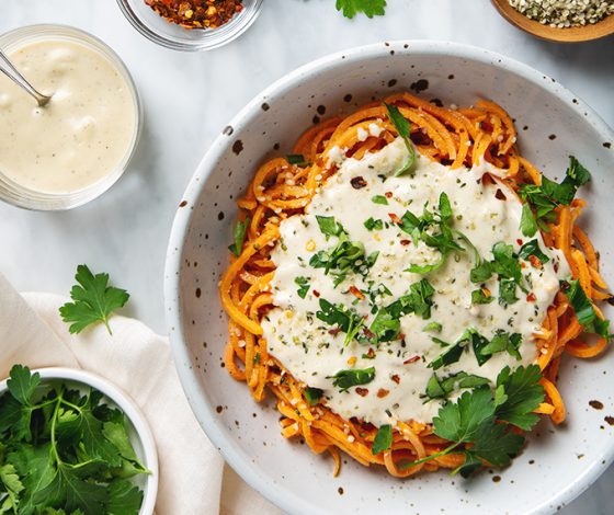 Healthy Sweet Potato Noodles with 5-Minute Vegan Alfredo Sauce! You're going to want to put this sauce on everything! | picklesnhoney.com #sweetpotato #noodles #vegan #alfredo #sauce #recipe #glutenfree #noodles #lunch #dinner